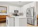 Modern kitchen with white cabinets, stainless steel appliances, and island at 8709 Palm Ranches Pl, Tampa, FL 33614
