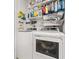 Laundry room with washer, dryer, and ample storage shelves at 8709 Palm Ranches Pl, Tampa, FL 33614
