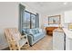 Cozy living room featuring a comfy sofa and rocking chair near large window at 8709 Palm Ranches Pl, Tampa, FL 33614