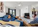 Bright living room featuring a blue sectional sofa and adjacent closet at 8709 Palm Ranches Pl, Tampa, FL 33614