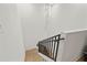 Modern staircase with sleek metal railing and light wood at 8709 Palm Ranches Pl, Tampa, FL 33614