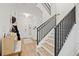 Modern staircase with black metal railings leading to the second floor at 8709 Palm Ranches Pl, Tampa, FL 33614