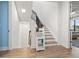 Modern staircase with light-colored wood and a white storage cabinet at 8709 Palm Ranches Pl, Tampa, FL 33614