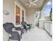 Inviting front porch with wicker chairs and a view of the street at 10002 Bentley Way, Tampa, FL 33626