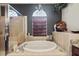 Bathroom featuring a large soaking tub, and a walk-in shower at 11550 Biddeford Pl, New Port Richey, FL 34654