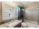 Bathroom with granite countertop and shower at 11550 Biddeford Pl, New Port Richey, FL 34654