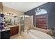 Spa-like bathroom with a soaking tub, shower, and granite countertop at 11550 Biddeford Pl, New Port Richey, FL 34654
