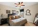 Spacious bedroom with a king-size bed and ceiling fan at 11550 Biddeford Pl, New Port Richey, FL 34654