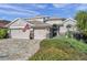 Two-story house with a three-car garage and manicured landscaping at 11550 Biddeford Pl, New Port Richey, FL 34654