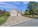 Two-story house with a three-car garage and a paver driveway at 11550 Biddeford Pl, New Port Richey, FL 34654