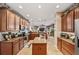 Bright kitchen with an island, lots of wood cabinetry, and views into Gathering room at 11550 Biddeford Pl, New Port Richey, FL 34654