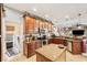 Large kitchen featuring an island, laundry access, and modern cabinetry at 11550 Biddeford Pl, New Port Richey, FL 34654