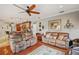 Relaxing living room with leather couches and a ceiling fan at 11550 Biddeford Pl, New Port Richey, FL 34654