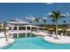 Resort-style pool with plenty of lounge chairs and umbrellas at 12199 Meditation Trl, Venice, FL 34293