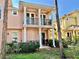 Rear view of two-story townhouse with balcony and patio at 130 Banyan Bay Dr, St Petersburg, FL 33705