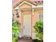 White front door with pineapple welcome mat at 130 Banyan Bay Dr, St Petersburg, FL 33705