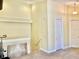 Spacious living room with high ceilings, neutral carpet, white trim, and an accent painting on the wall at 130 Banyan Bay Dr, St Petersburg, FL 33705
