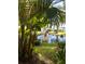 Lush greenery surrounds a tranquil pond with a small waterfall feature, creating a serene outdoor space at 130 Banyan Bay Dr, St Petersburg, FL 33705