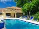 Community pool with patio furniture and a shaded seating area at 130 Banyan Bay Dr, St Petersburg, FL 33705