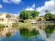 Beautiful waterfront property with colorful boats, lush landscaping, and a sunny sky at 130 Banyan Bay Dr, St Petersburg, FL 33705