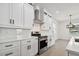 Modern kitchen with white cabinets, stainless steel appliances, and quartz countertops at 1309 E Cayuga N St, Tampa, FL 33603