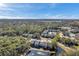 Aerial view of apartment buildings nestled in trees near a lake at 1400 Gandy N Blvd # 202, St Petersburg, FL 33702