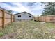 Spacious backyard with a large grassy area and a wooden fence at 14430 10Th. St, Dade City, FL 33523