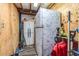 Unfinished basement area with a refrigerator and tools at 14430 10Th. St, Dade City, FL 33523