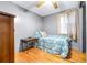 Small bedroom with wood floors, a single bed, and a wooden dresser at 14430 10Th. St, Dade City, FL 33523