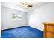 Spacious bedroom with blue carpet and a ceiling fan at 14430 10Th. St, Dade City, FL 33523