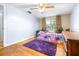 Bedroom with twin bed, dresser, and purple rug at 14430 10Th. St, Dade City, FL 33523