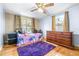 Bedroom with twin bed, dresser, and purple rug at 14430 10Th. St, Dade City, FL 33523