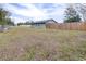 Gray house with wooden fence and expansive lawn at 14430 10Th. St, Dade City, FL 33523