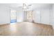 Bright living room with light wood flooring and ceiling fan at 14430 10Th. St, Dade City, FL 33523