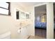 Clean bathroom with updated vanity and a view into the bedroom at 1485 Halsey Dr # 101, Dunedin, FL 34698