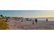 People relaxing and playing on a sandy beach near the ocean at 1696 Wilmar Ave, Tarpon Springs, FL 34689