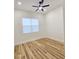 Bright bedroom with wood-look floors and ceiling fan at 1696 Wilmar Ave, Tarpon Springs, FL 34689