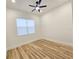 Bright bedroom with wood-look floors and ceiling fan at 1696 Wilmar Ave, Tarpon Springs, FL 34689