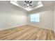 Spacious bedroom with wood-look floors and ceiling fan at 1696 Wilmar Ave, Tarpon Springs, FL 34689