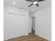 Bright bedroom with double doors leading to a large closet and hardwood flooring at 1696 Wilmar Ave, Tarpon Springs, FL 34689