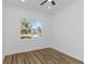 Bright bedroom with wood-look floors and a large window at 1696 Wilmar Ave, Tarpon Springs, FL 34689