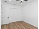 Light-filled bedroom with hardwood floors and double door closet at 1696 Wilmar Ave, Tarpon Springs, FL 34689