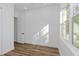 Bright bedroom with hardwood floors and large windows at 1696 Wilmar Ave, Tarpon Springs, FL 34689