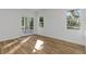 Bright bedroom with hardwood floors and access to a private balcony at 1696 Wilmar Ave, Tarpon Springs, FL 34689