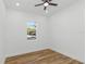 Spacious bedroom featuring wood-look floors and a large window at 1696 Wilmar Ave, Tarpon Springs, FL 34689