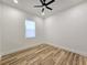 Spacious bedroom with wood-look floors and ceiling fan at 1696 Wilmar Ave, Tarpon Springs, FL 34689