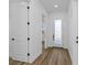 Bright entryway with hardwood floors and white doors at 1696 Wilmar Ave, Tarpon Springs, FL 34689