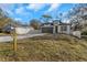 Modern home's exterior, featuring a driveway and fenced yard at 1696 Wilmar Ave, Tarpon Springs, FL 34689