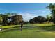 Landscaped golf course with a player teeing off at 1696 Wilmar Ave, Tarpon Springs, FL 34689