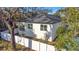 Single story home with white exterior and a fenced backyard at 1696 Wilmar Ave, Tarpon Springs, FL 34689